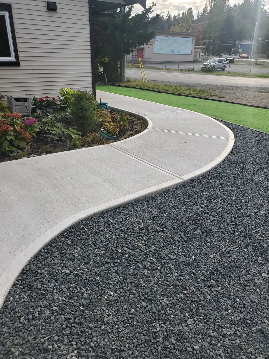 Finished curved driveway and gravel landscaping by Mirror Excavating in Nanaimo