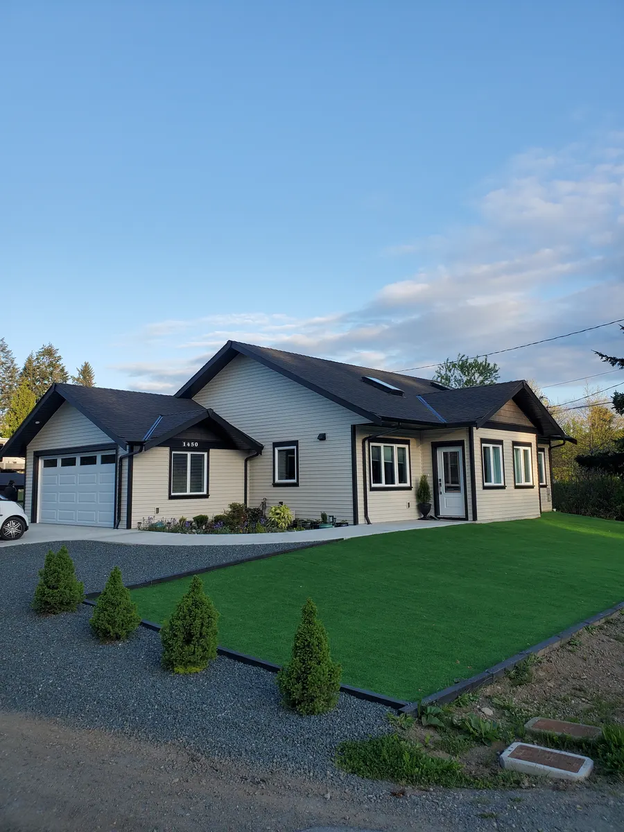 Finished residential landscaping with artificial turf and gravel edging