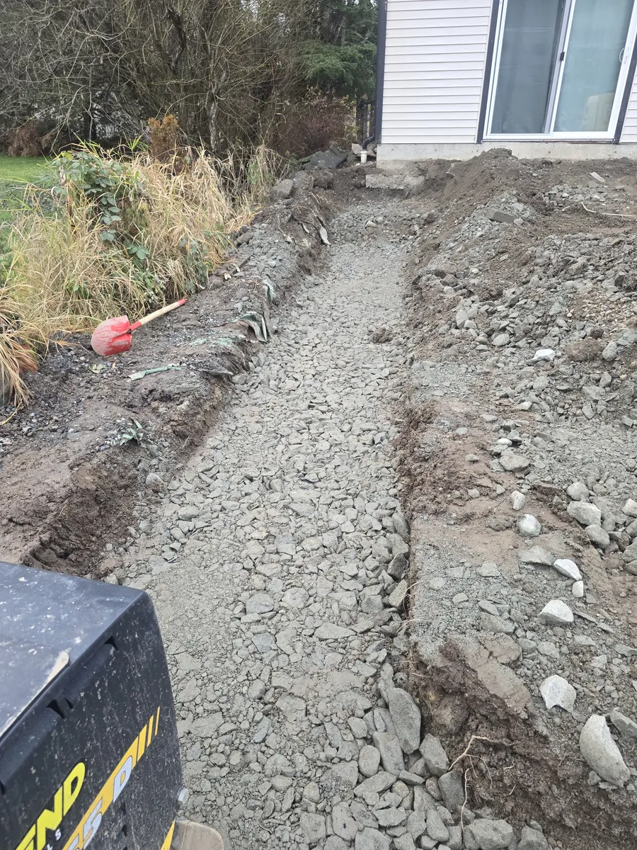 Drainage trench and gravel base preparation for residential site services